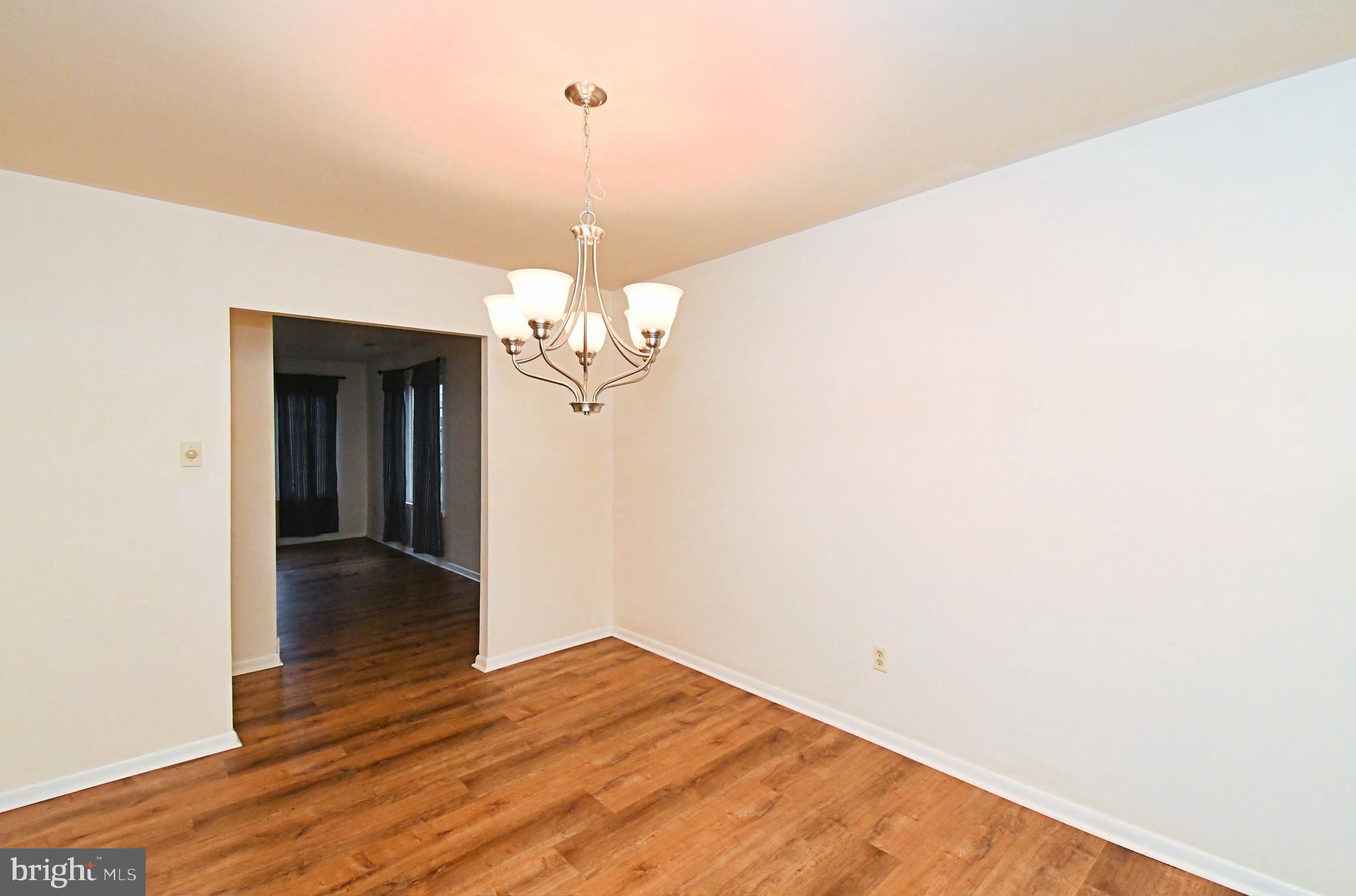 8 Pennington Lane Quakertown, PA 18951 - Photo 16 of 58 a view of a room with wooden floor and chandelier