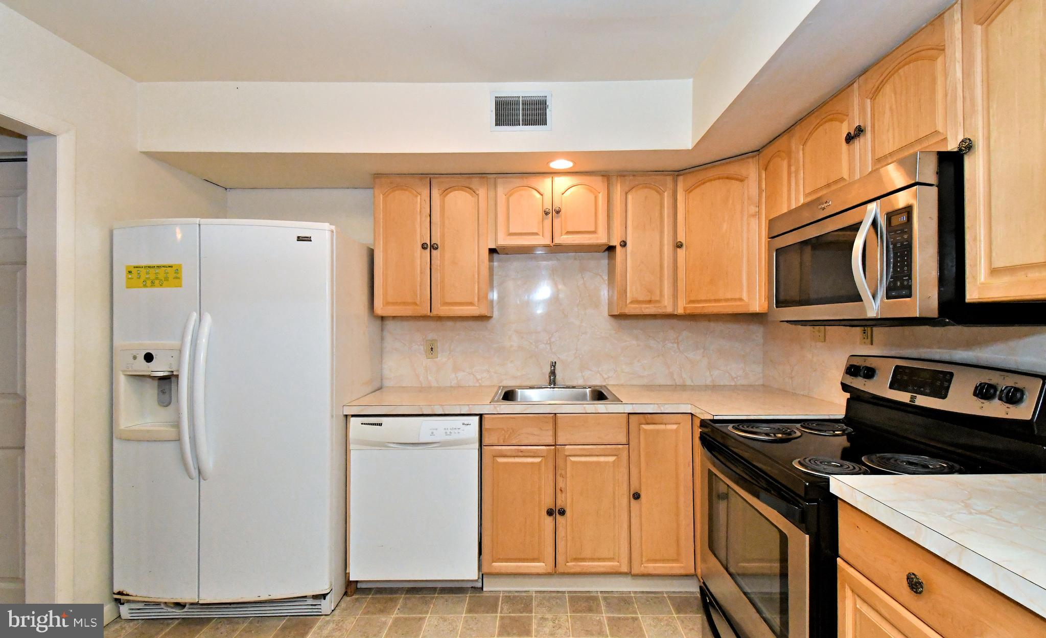 8 Pennington Lane Quakertown, PA 18951 - Photo 17 of 58 a kitchen with stainless steel appliances granite countertop a refrigerator sink and white cabinets