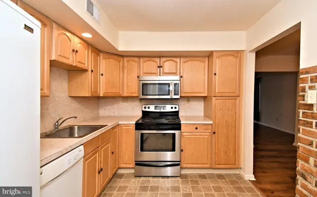a kitchen with stainless steel appliances a stove a microwave and a refrigerator