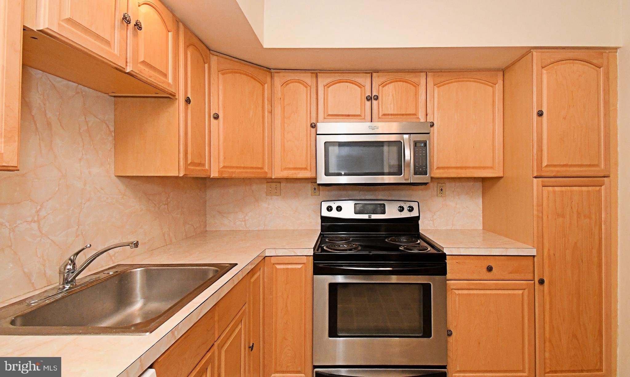 8 Pennington Lane Quakertown, PA 18951 - Photo 20 of 58 a kitchen with granite countertop a sink stove and microwave