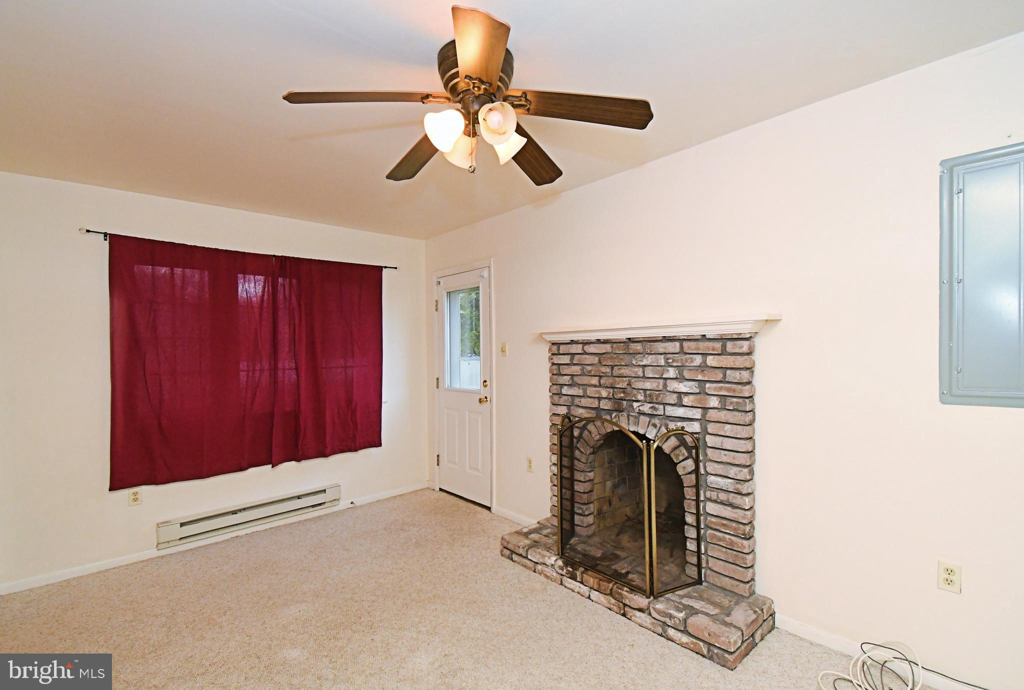 8 Pennington Lane Quakertown, PA 18951 - Photo 23 of 58 a view of an empty room with chandelier fan and fire place