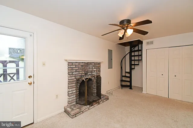 a view of staircase with white walls and a painting on the wall