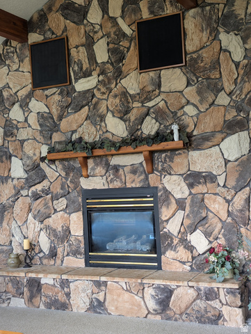 1040 West Mill Road Ferron, UT 84523 - Photo 15 of 117 Floor-to-ceiling stone fireplace featuring a built-in firebox, stone hearth, and a wood mantel