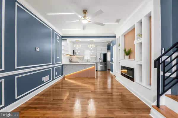a view of an entryway with wooden floor and a fire place