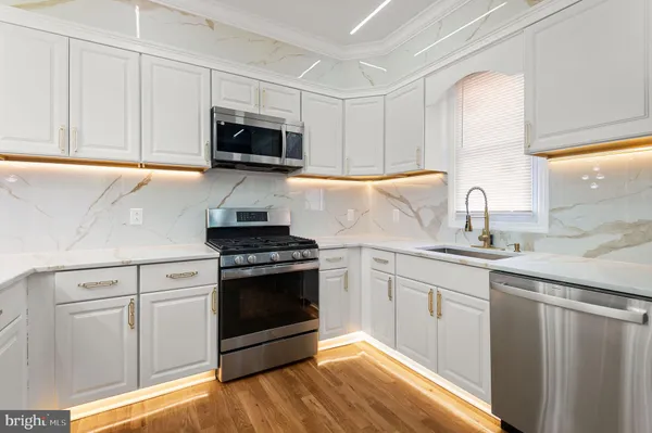 a kitchen with stainless steel appliances granite countertop a stove and a sink