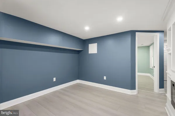 a view of an empty room with a fireplace and a window