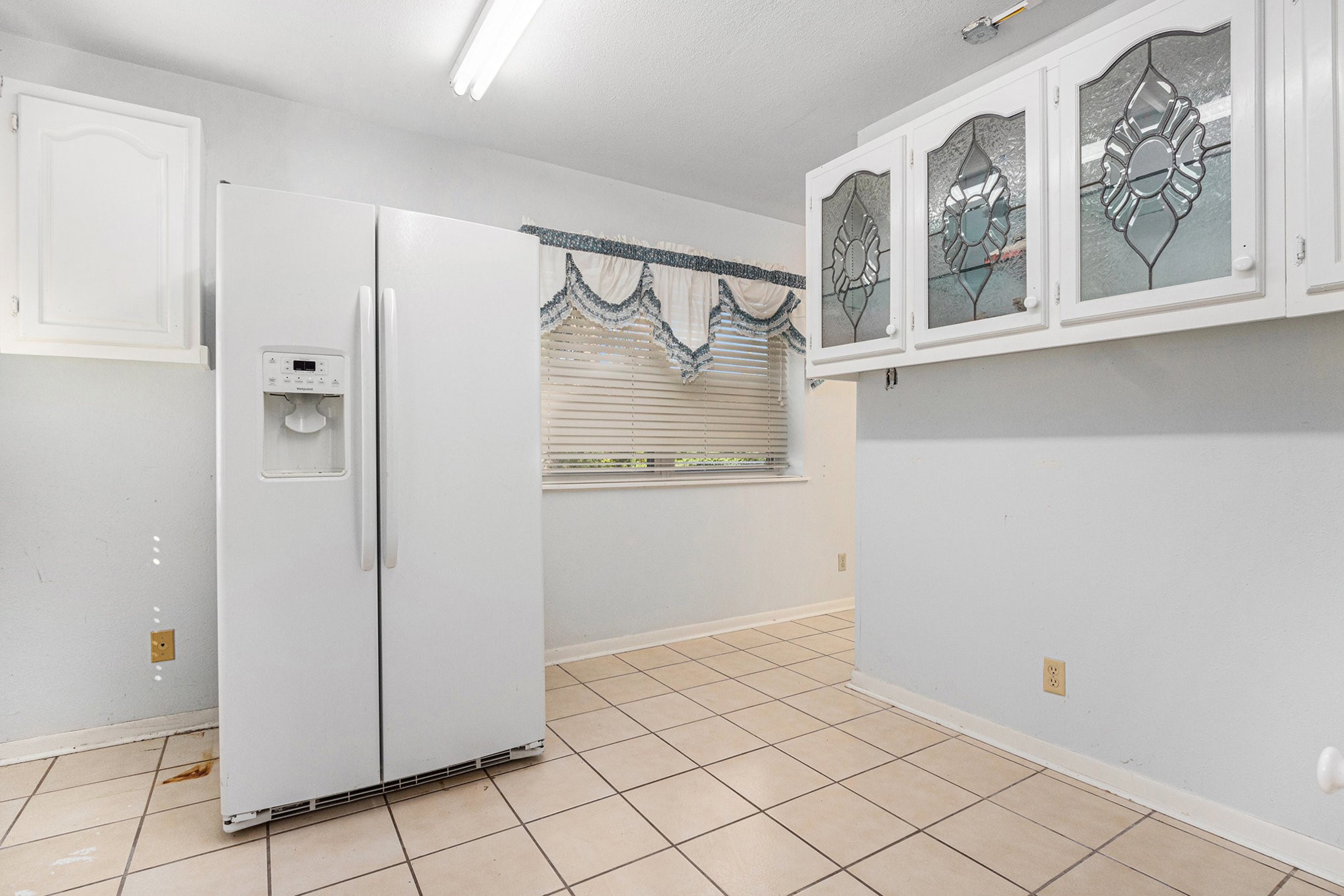 4709 Frontier Drive Houston, TX 77041 - Photo 16 of 20 a bathroom with a glass shower door and a window
