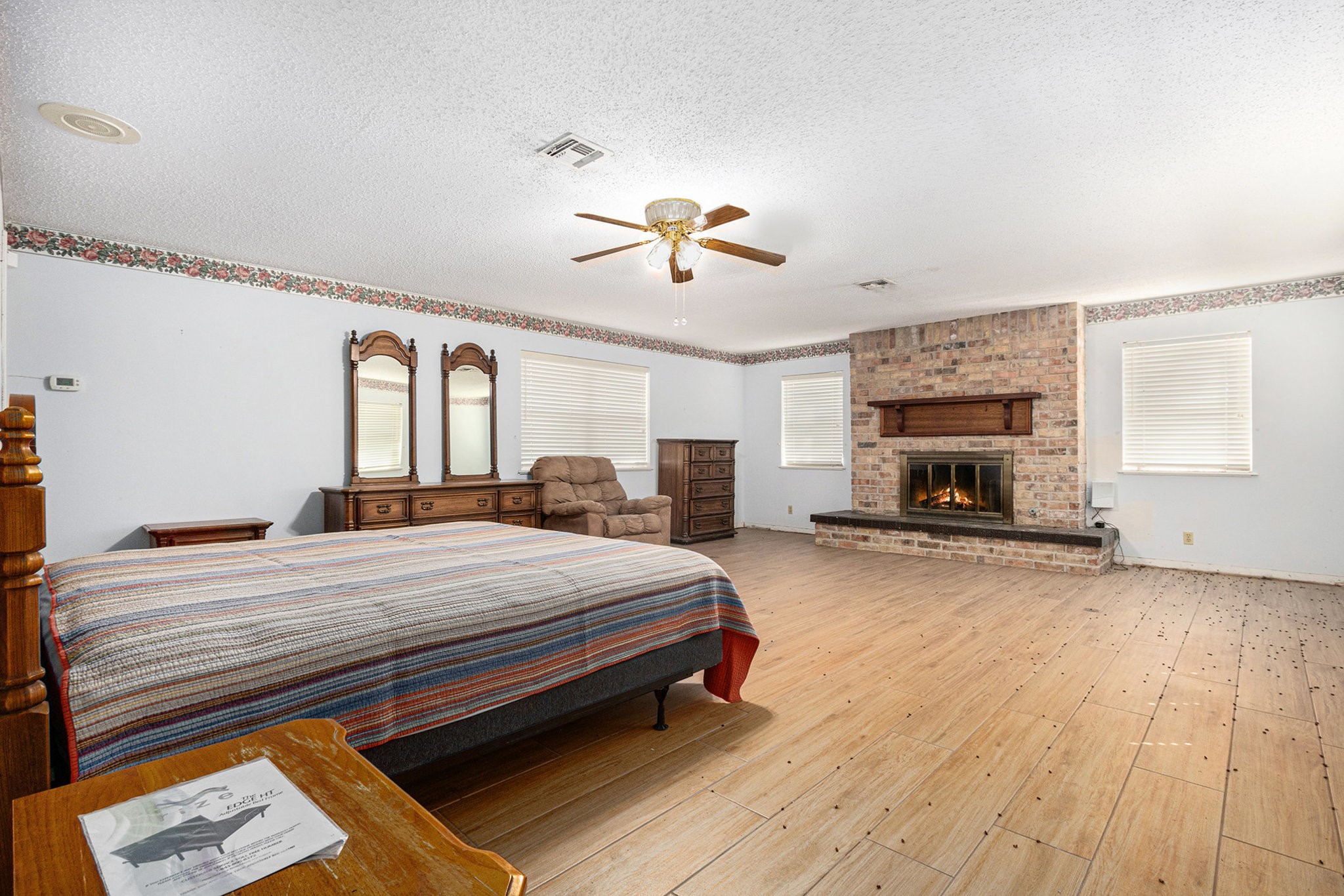 4709 Frontier Drive Houston, TX 77041 - Photo 9 of 20 a bedroom with a bed and a chandelier