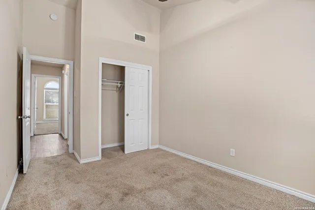 an empty room with closet and a bathroom