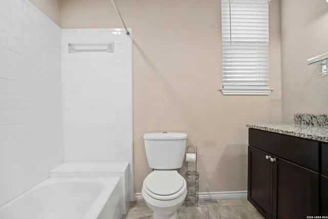 a bathroom with a toilet and a bathtub