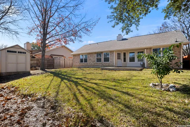 a front view of a house with a yard table and chairs