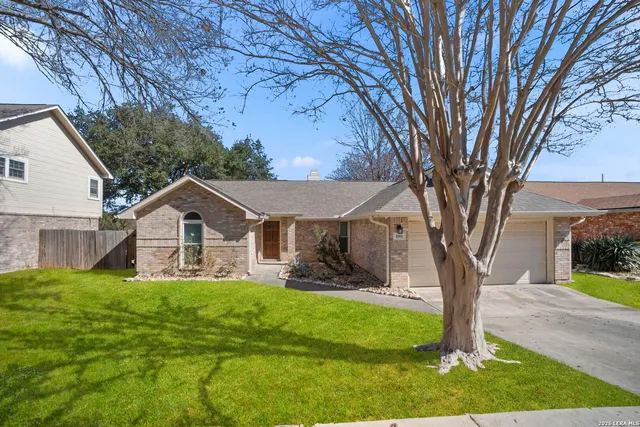 a front view of a house with yard and green space