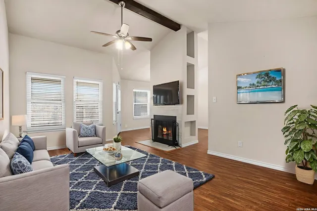 a living room with furniture fireplace and flat screen tv