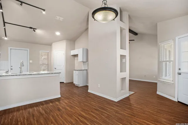 a kitchen with stainless steel appliances a refrigerator and wooden floor
