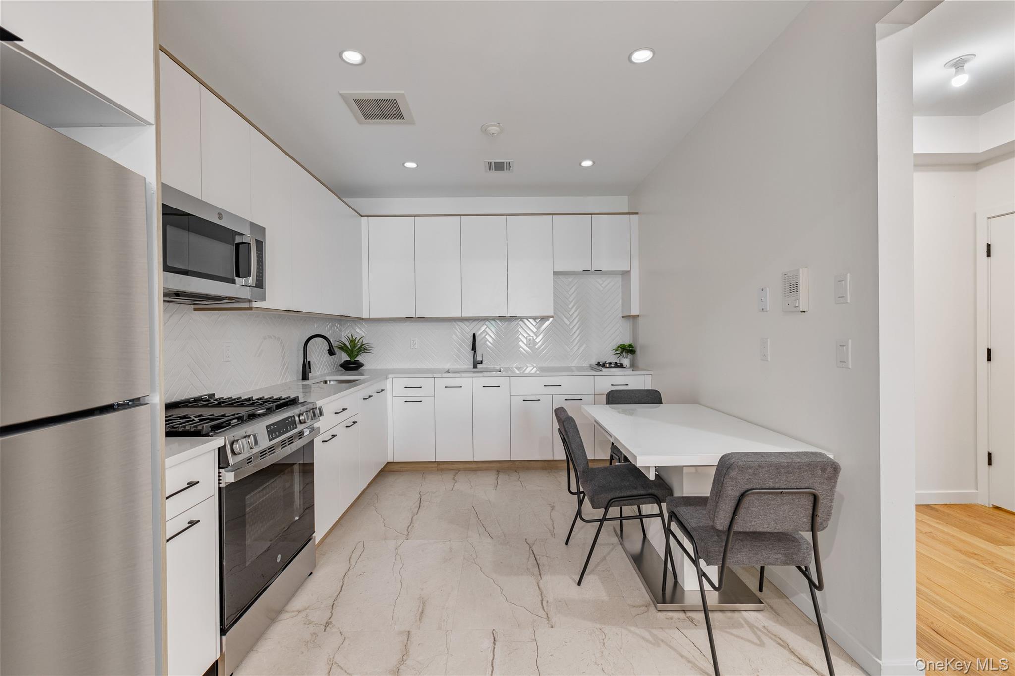 17 Union Road, Unit 110 Spring Valley, NY 10977 - Photo 8 of 16 a kitchen with granite countertop white cabinets and stainless steel appliances