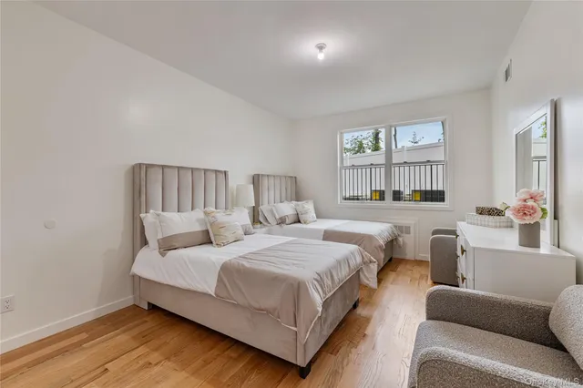 a bedroom with a bed couch and a window