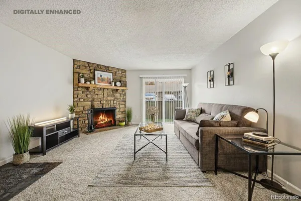 a living room with furniture and a fireplace