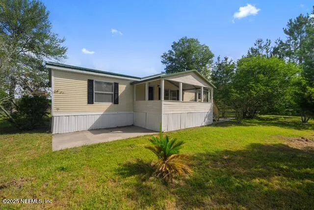 a front view of house with yard and trees