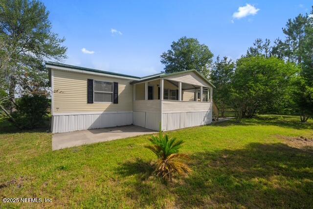 a front view of house with yard and trees