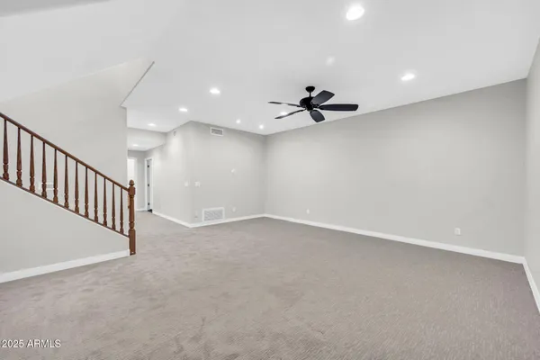 wooden floor in an empty room with a ceiling fan