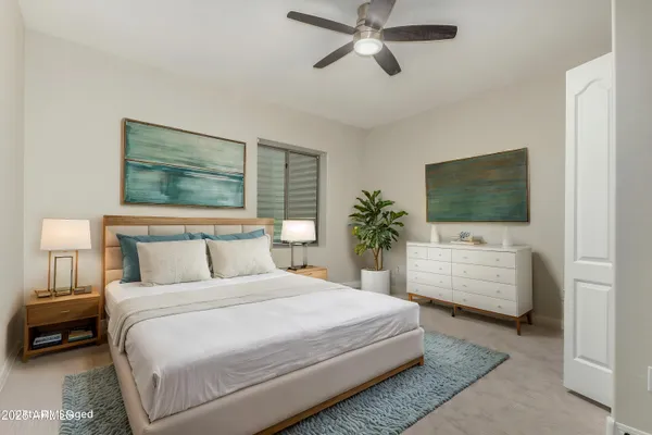 a bedroom with a large bed and a flat screen tv