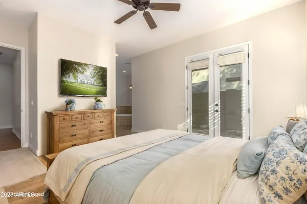 a bathroom with a tub sink and mirror