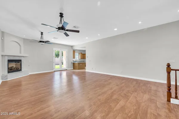 a view of empty room with wooden floor