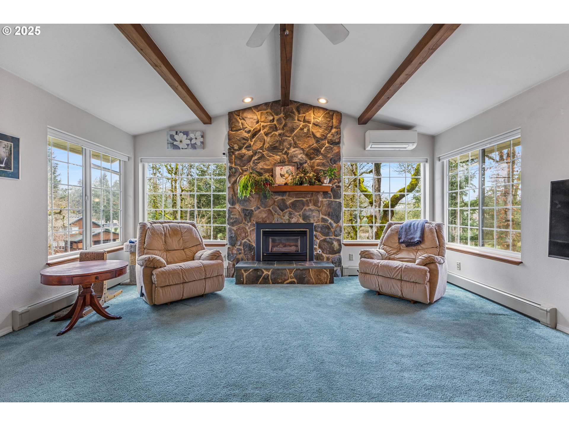 17576 North Abiqua Road Silverton, OR 97381 - Photo 11 of 40 a living room with furniture a fireplace and a floor to ceiling window