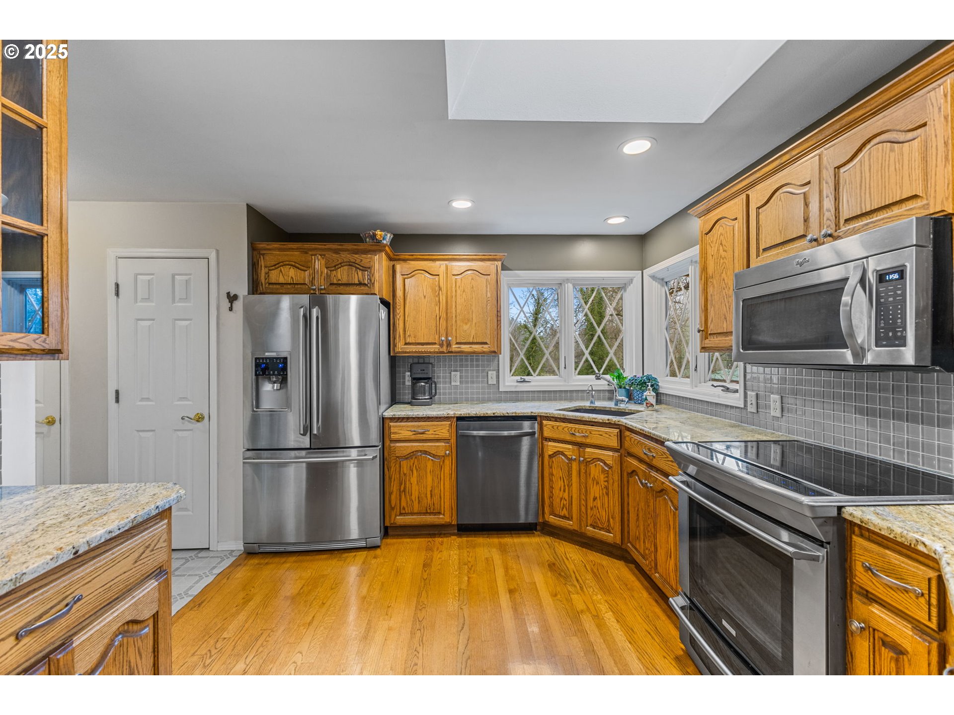 17576 North Abiqua Road Silverton, OR 97381 - Photo 3 of 40 a kitchen with stainless steel appliances granite countertop a refrigerator a stove top oven and a sink