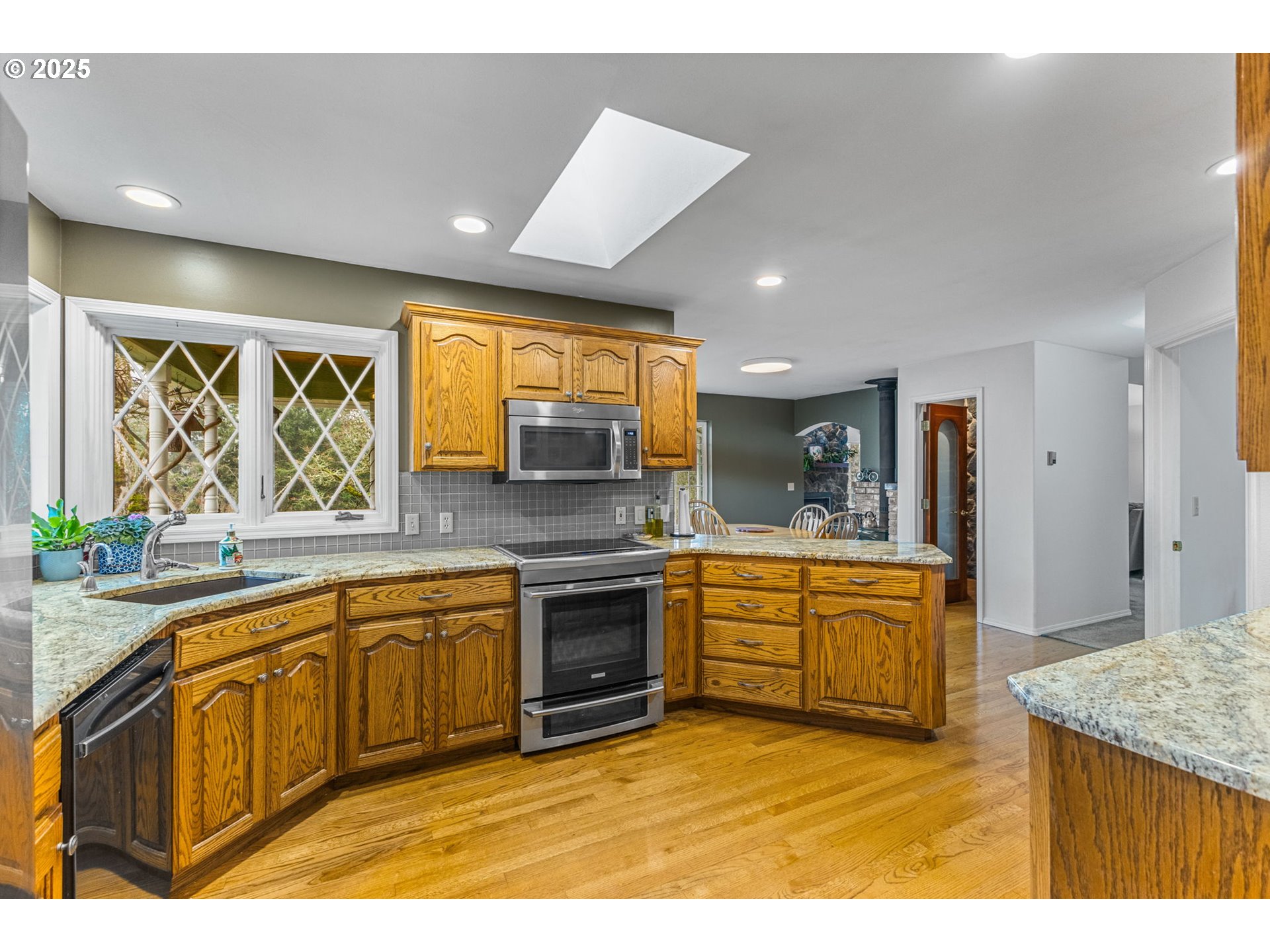 17576 North Abiqua Road Silverton, OR 97381 - Photo 5 of 40 a large kitchen with stainless steel appliances granite countertop a sink and cabinets