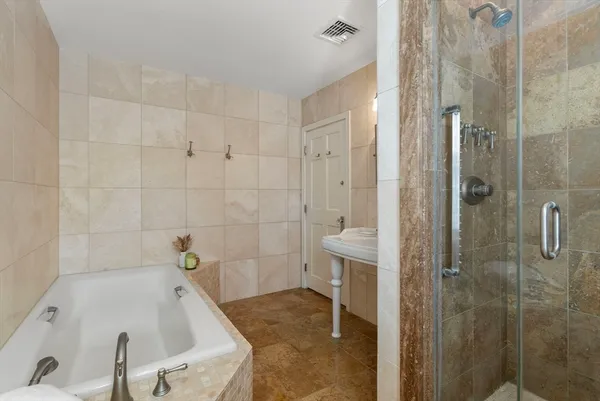 a bathroom with a tub and shower