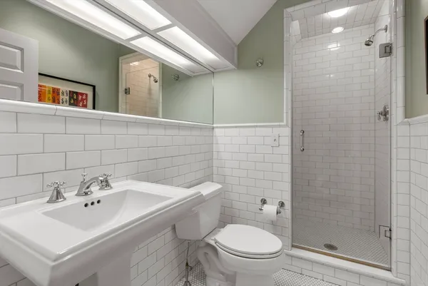 a bathroom with a sink toilet and shower