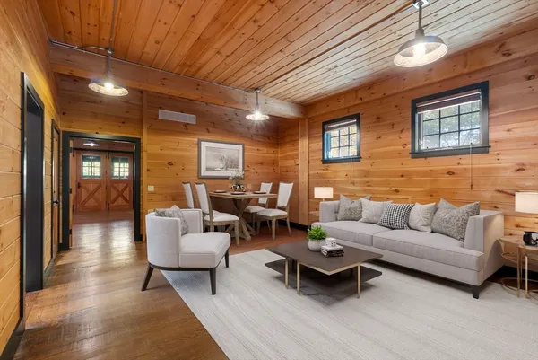 a living room with furniture a ceiling fan and a rug