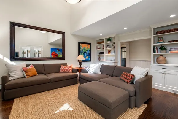 a living room with furniture and a painting on the wall