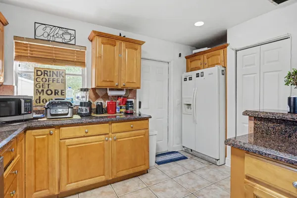 a kitchen with cabinets and window