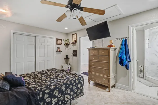 a bedroom with a bed and a flat tv screen
