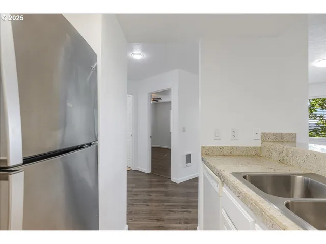 a kitchen with a sink and refrigerator