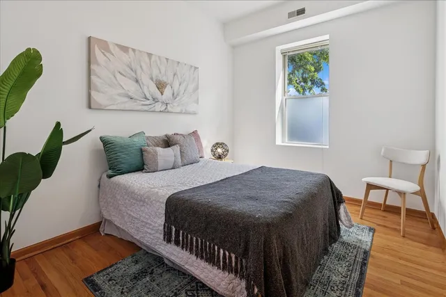a bedroom with a bed and a painting on the wall