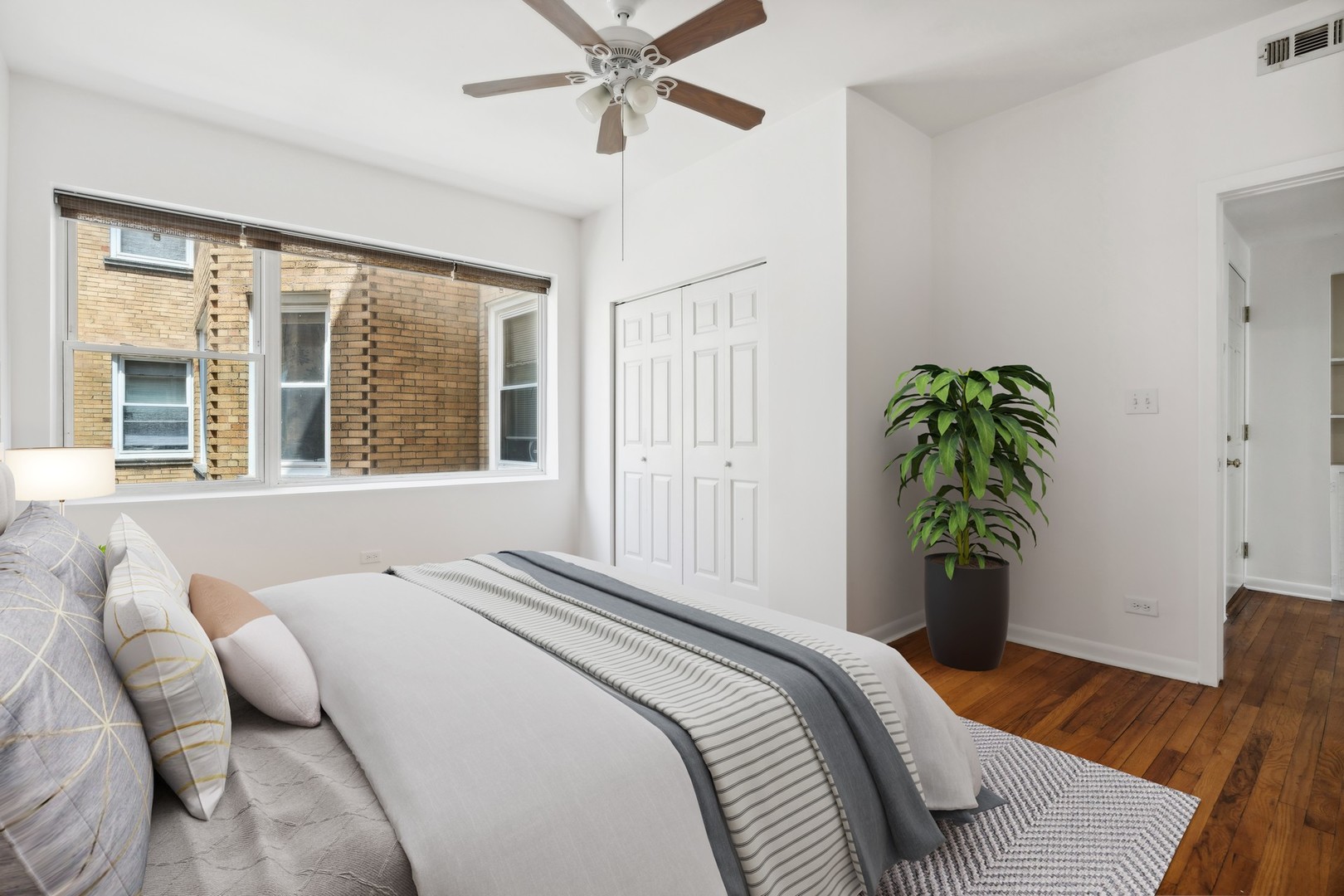 4915 North Avers Avenue, Unit 2CS Chicago, IL 60625 - Photo 12 of 18 a bedroom with a bed and a potted plant