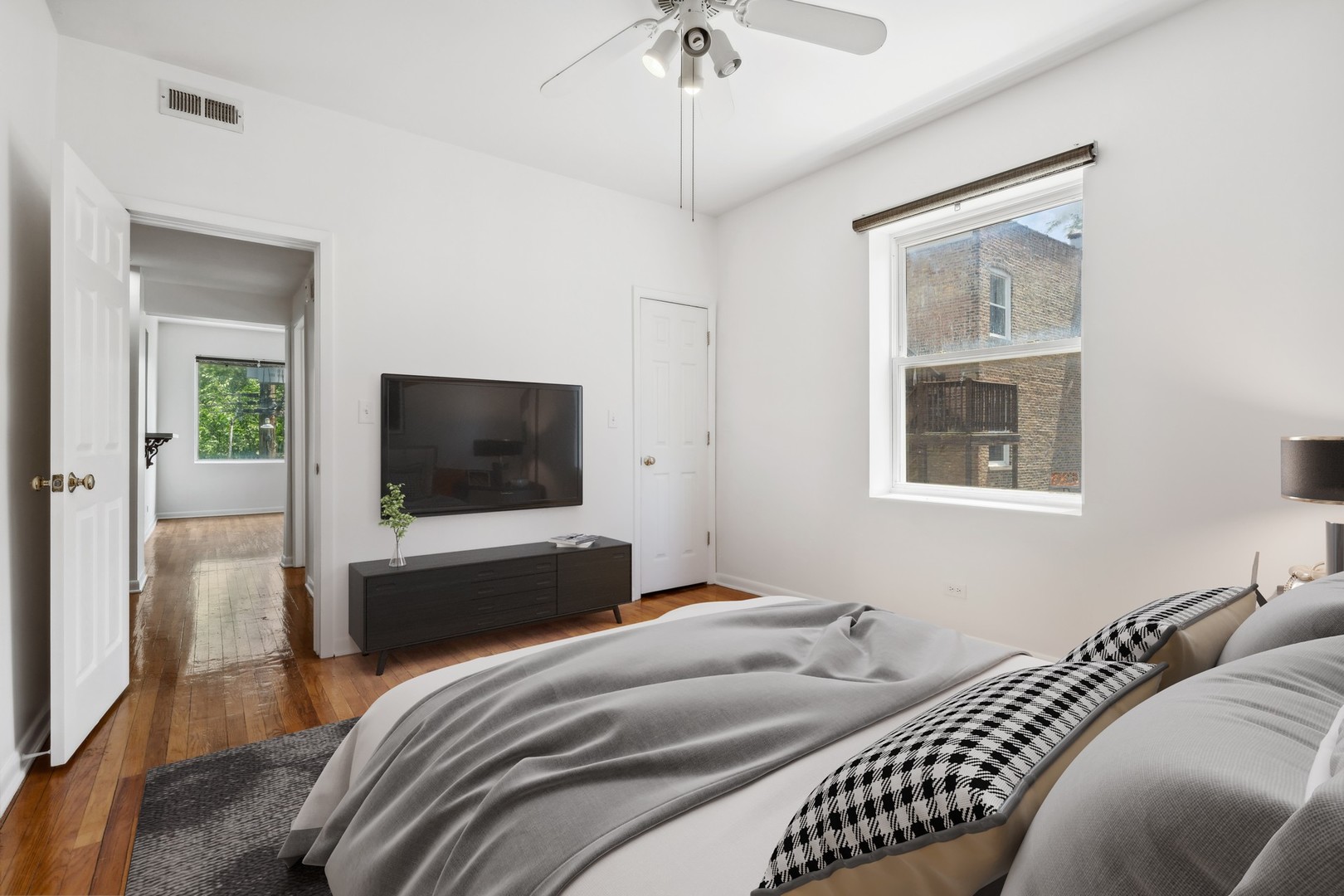 4915 North Avers Avenue, Unit 2CS Chicago, IL 60625 - Photo 14 of 18 a bedroom with a bed and a flat screen tv