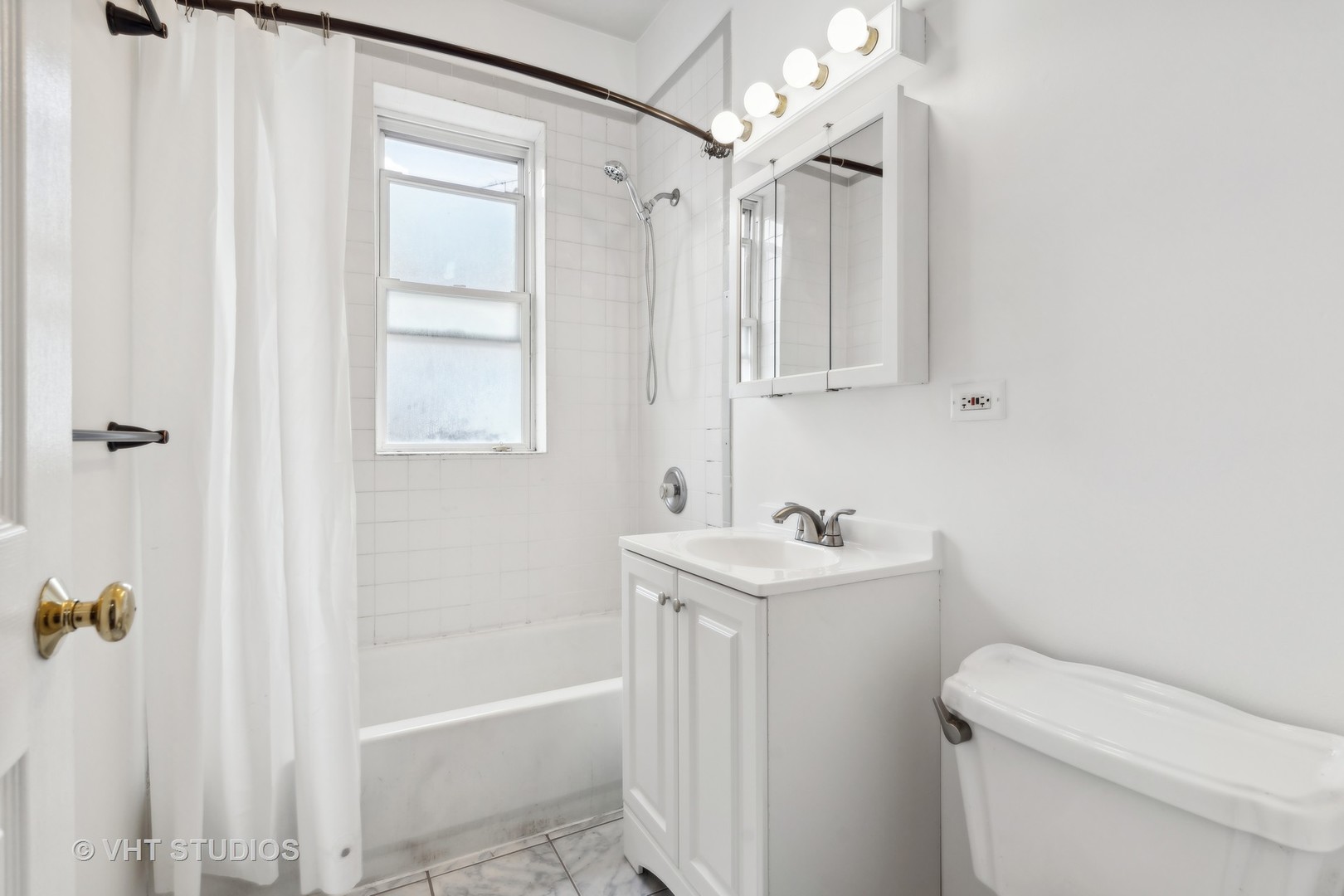 4915 North Avers Avenue, Unit 2CS Chicago, IL 60625 - Photo 15 of 18 a bathroom with a sink a toilet and shower