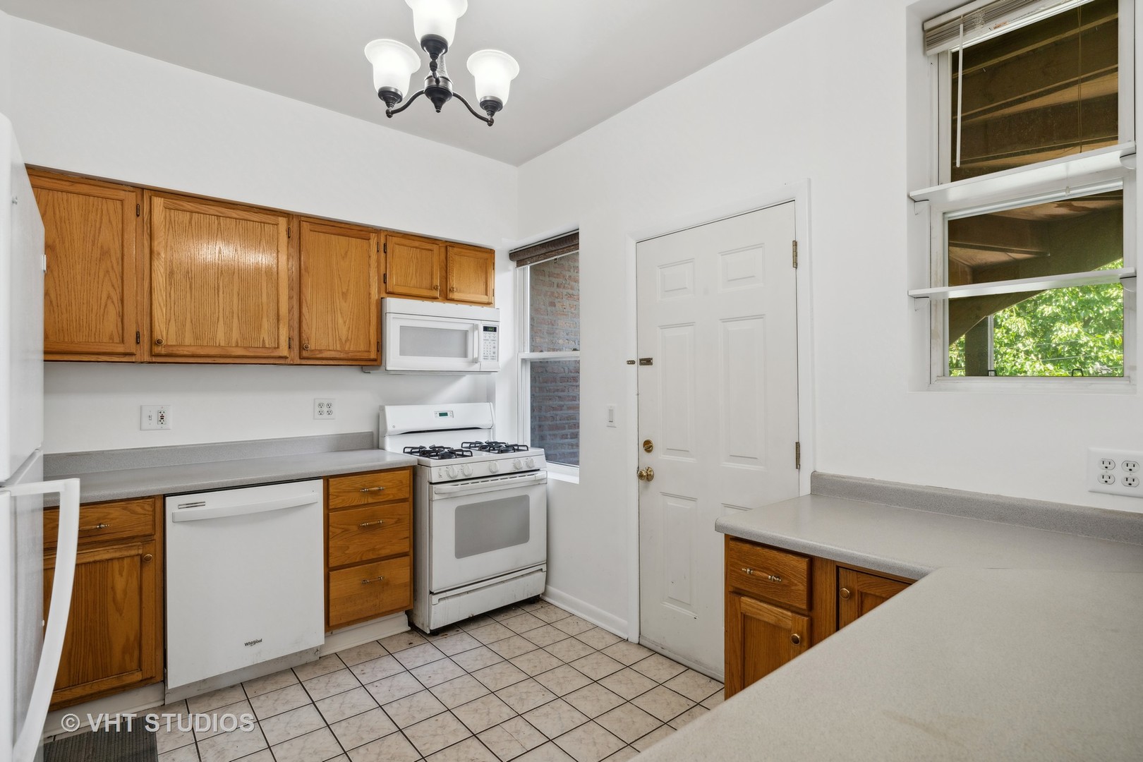4915 North Avers Avenue, Unit 2CS Chicago, IL 60625 - Photo 8 of 18 a kitchen with stainless steel appliances granite countertop a stove a sink and a microwave