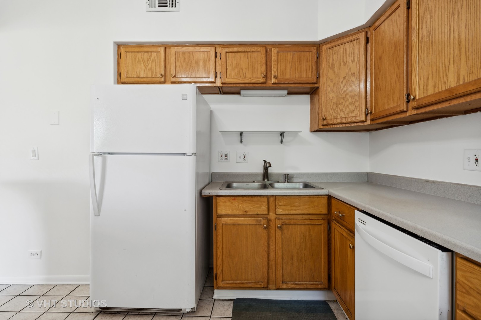 4915 North Avers Avenue, Unit 2CS Chicago, IL 60625 - Photo 9 of 18 a kitchen with stainless steel appliances granite countertop a sink and a refrigerator