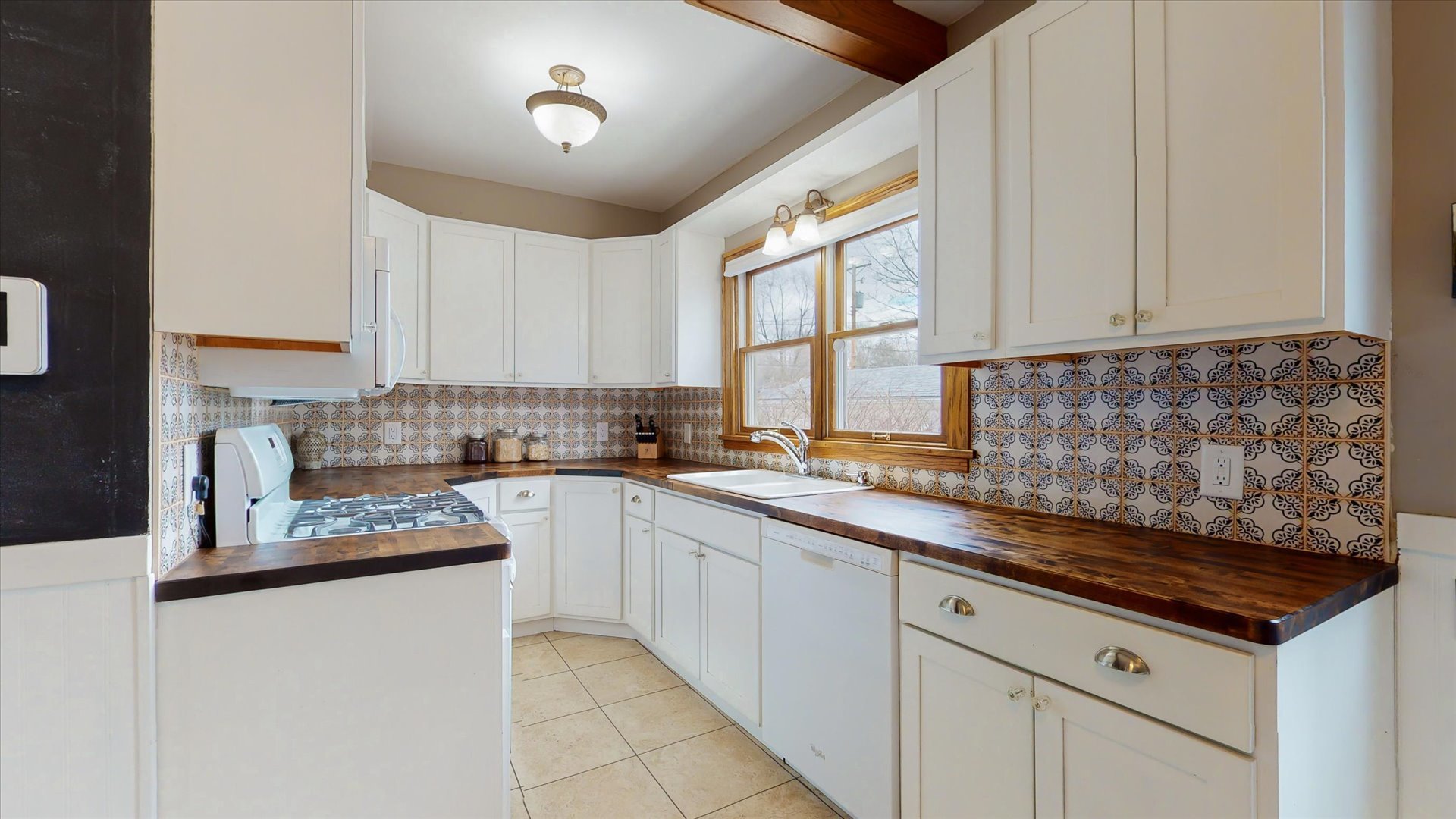 506 North Edwin Street Champaign, IL 61821 - Photo 17 of 45 a kitchen with stainless steel appliances granite countertop a sink stove and cabinets