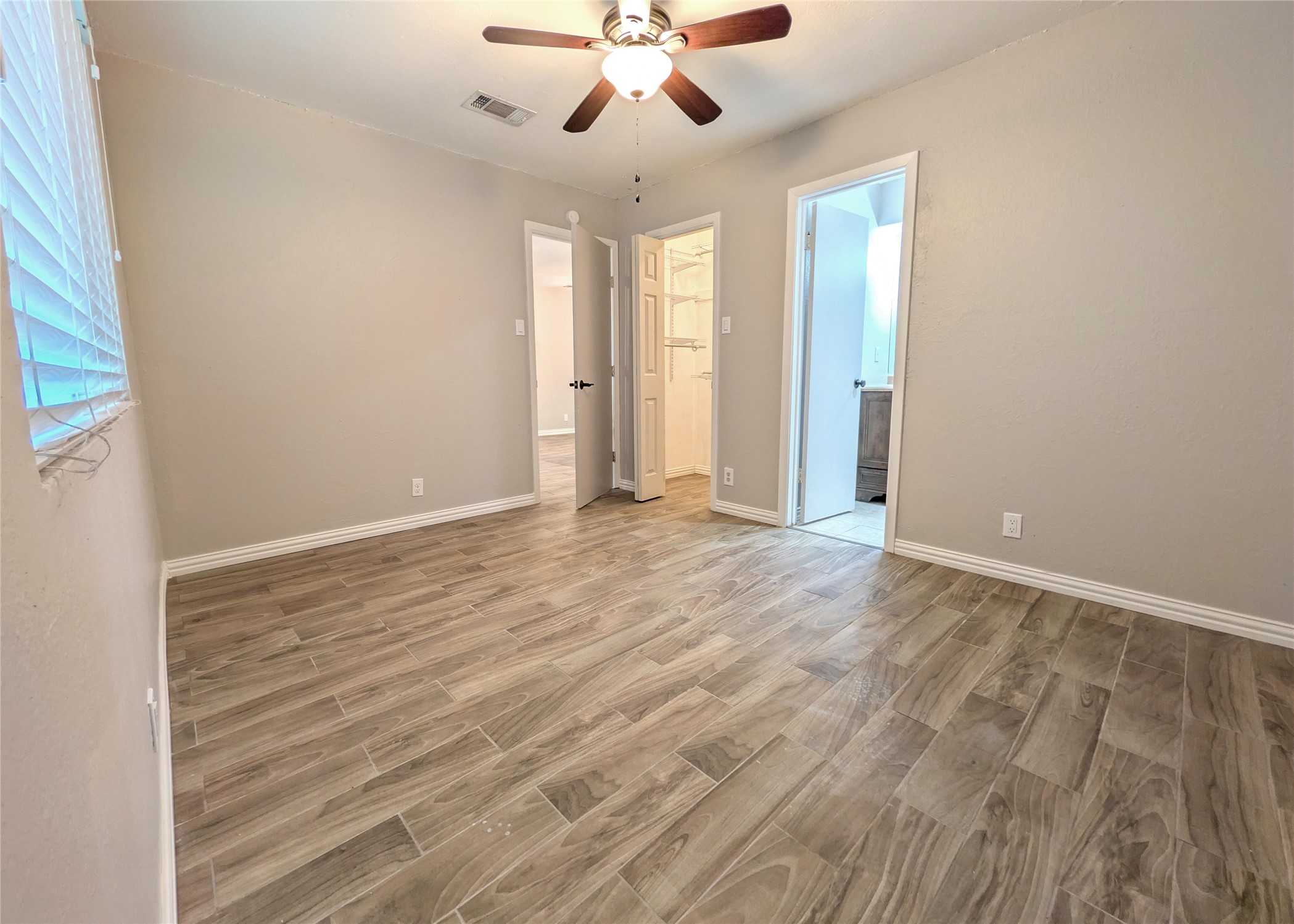 12601 Turtle Rock Road, Unit B Austin, TX 78729 - Photo 7 of 20 Primary Bedroom is on the right side when walking in the front door (furthest from the street). Extra storage bars/shelves in closet.