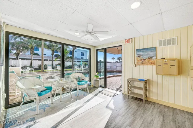 a living room with furniture and a floor to ceiling window