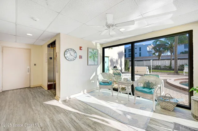 a living room with large window and furniture