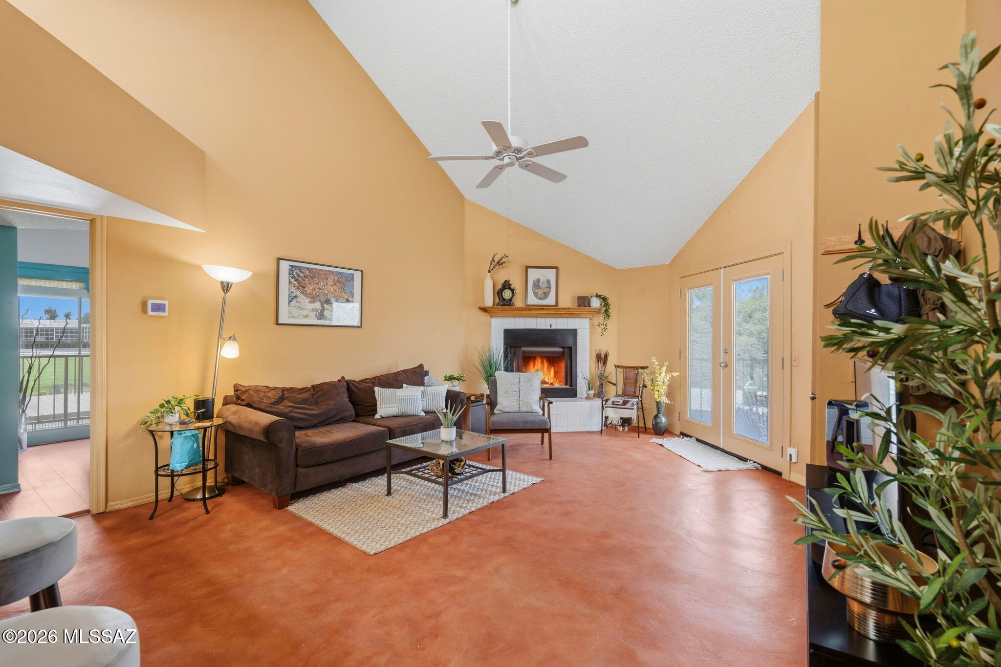 1200 East River Road, Unit G87 Tucson, AZ 85718 - Photo 4 of 30 a living room with furniture a fireplace and a potted plant