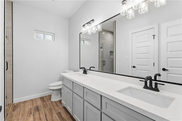 a bathroom with a sink a toilet and a mirror