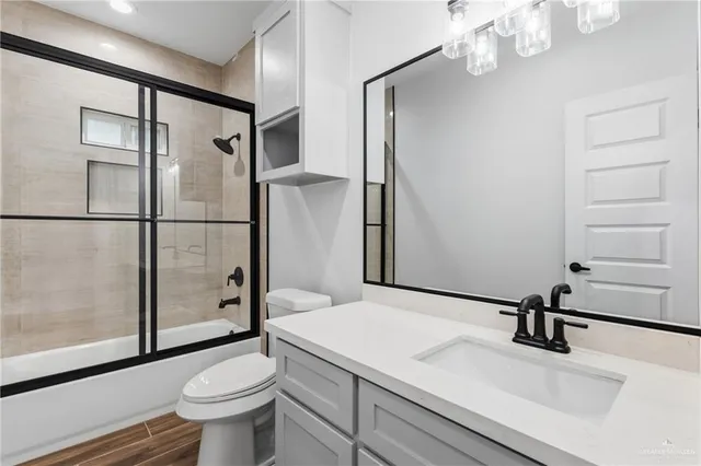 a bathroom with a sink toilet and shower